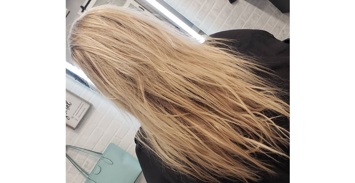 A detailed look at blonde hair exhibiting signs of damage and dryness, in need of repair.